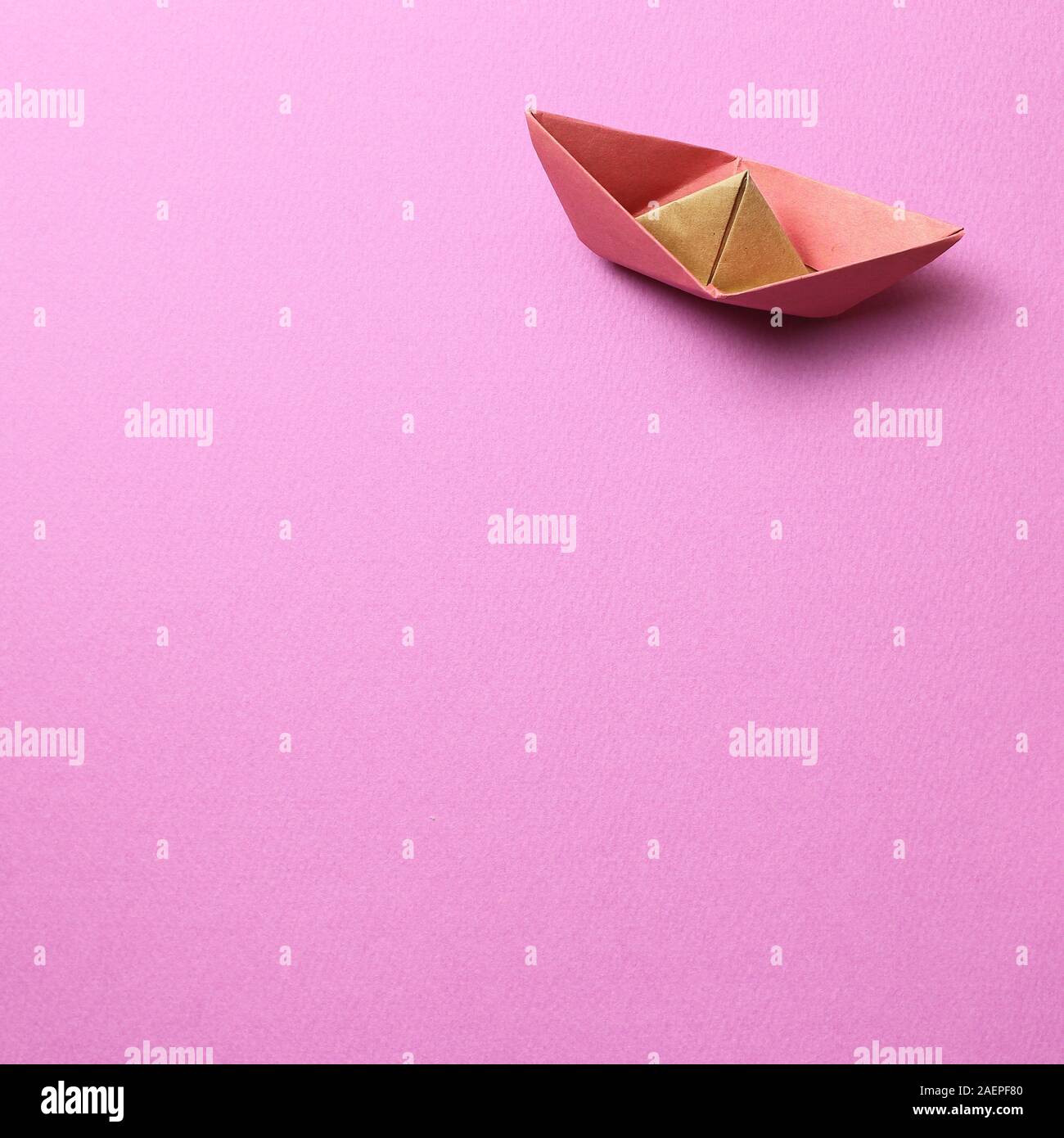 Paper ship on pink background Stock Photo