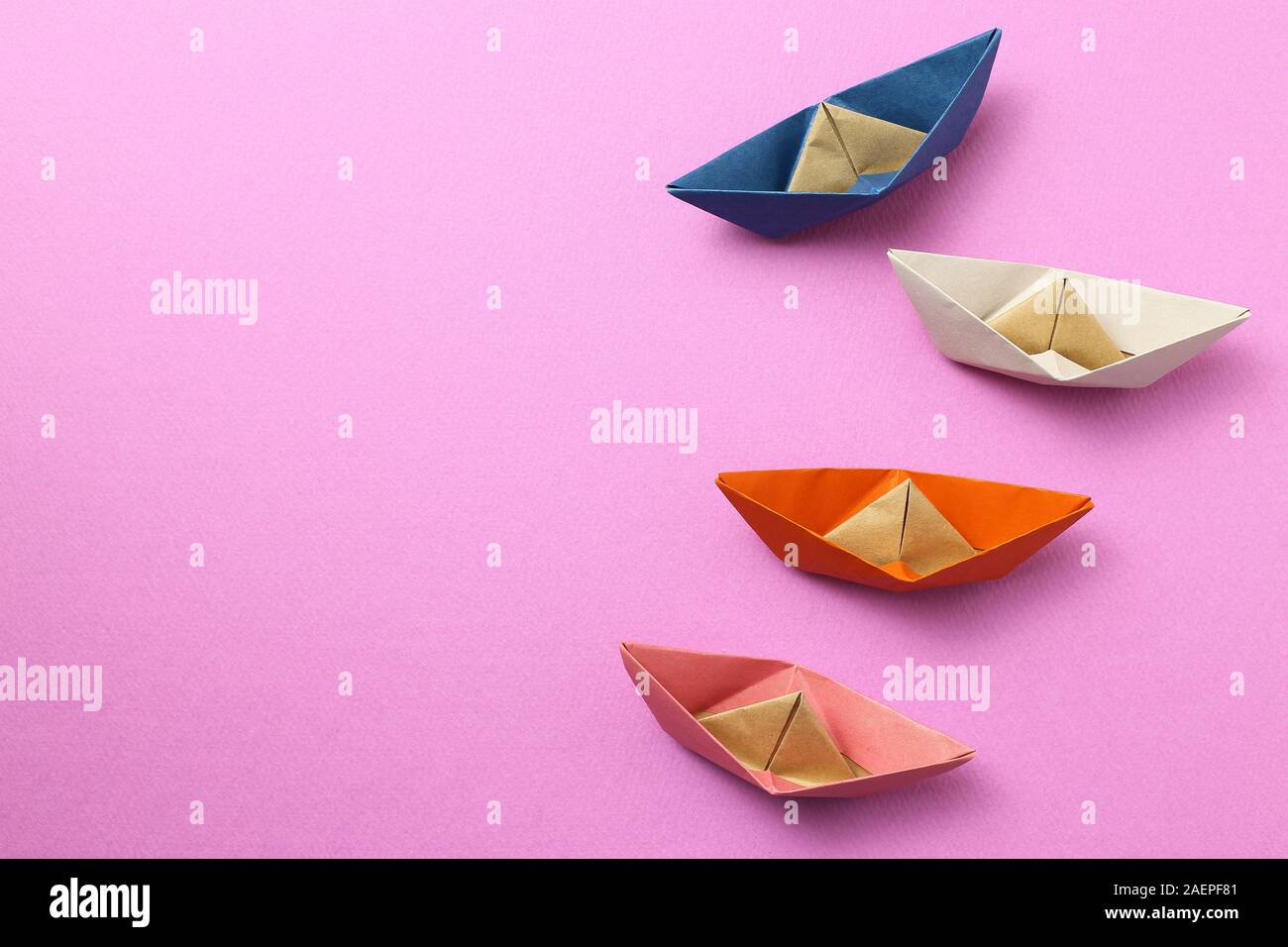 Paper ship on pink background Stock Photo