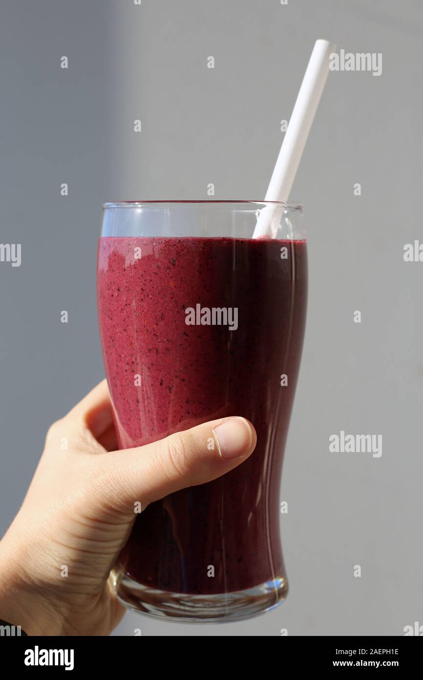 Pink / purple homemade berry and vegetable smoothie with vibrant color and plenty of vitamins. Healthy and delicious drink for sunny summer days. Stock Photo