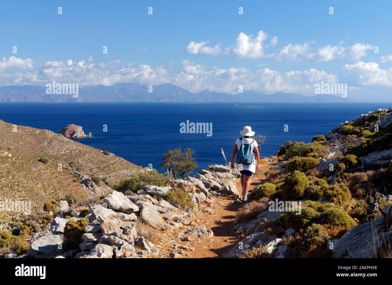 Walker on Footpath from Mikro Horio to Lethra Beach, Tilos, Dodecanese islands, Southern Aegean, Greece. Stock Photo