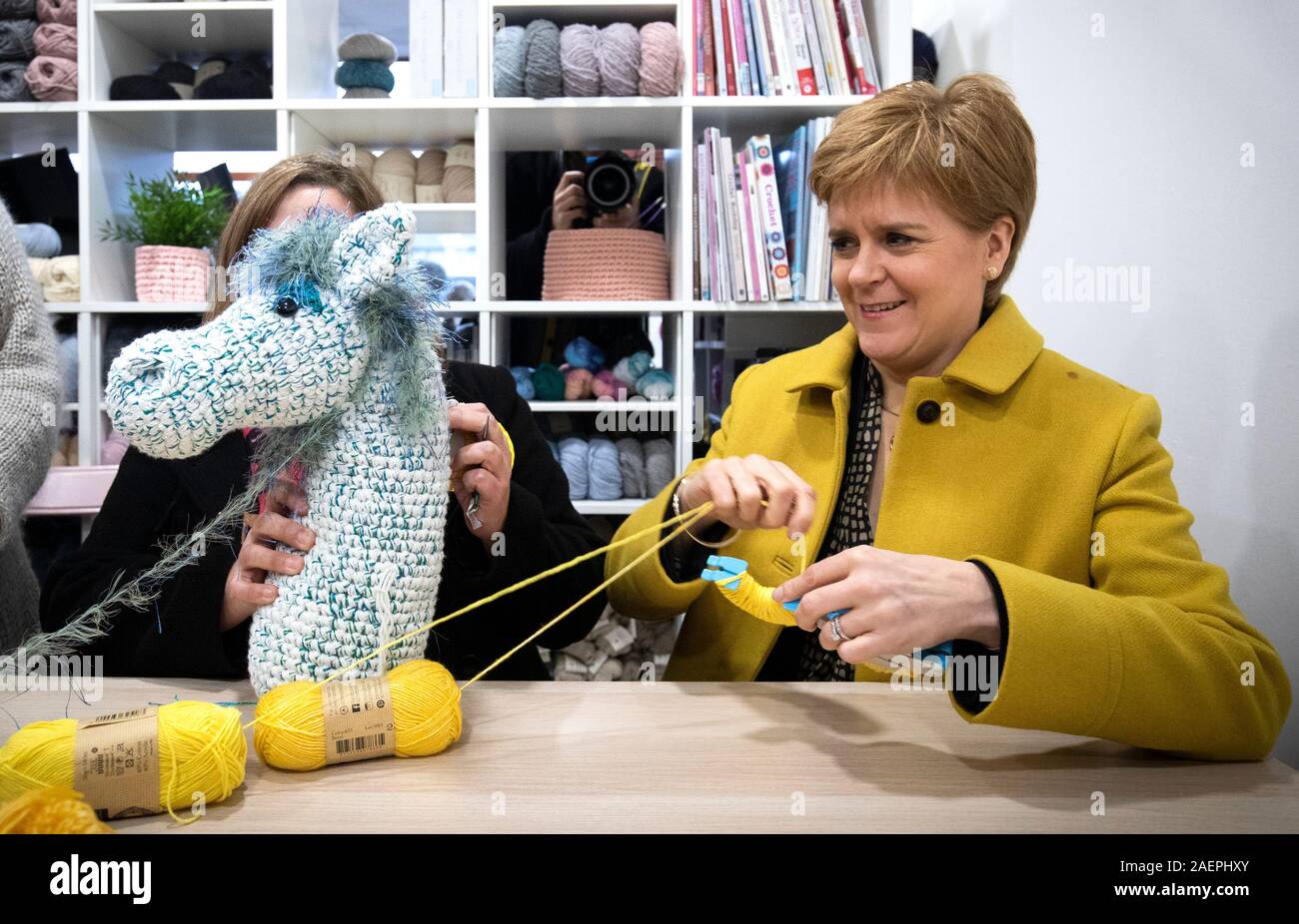 SNP leader Nicola Sturgeon (right) makes pom-poms with SNP candidate Kirsten Oswald, as they take part in a knitting workshop during a visit to the Orry Mill, Glasgow, while on the General Election campaign trail. Stock Photo