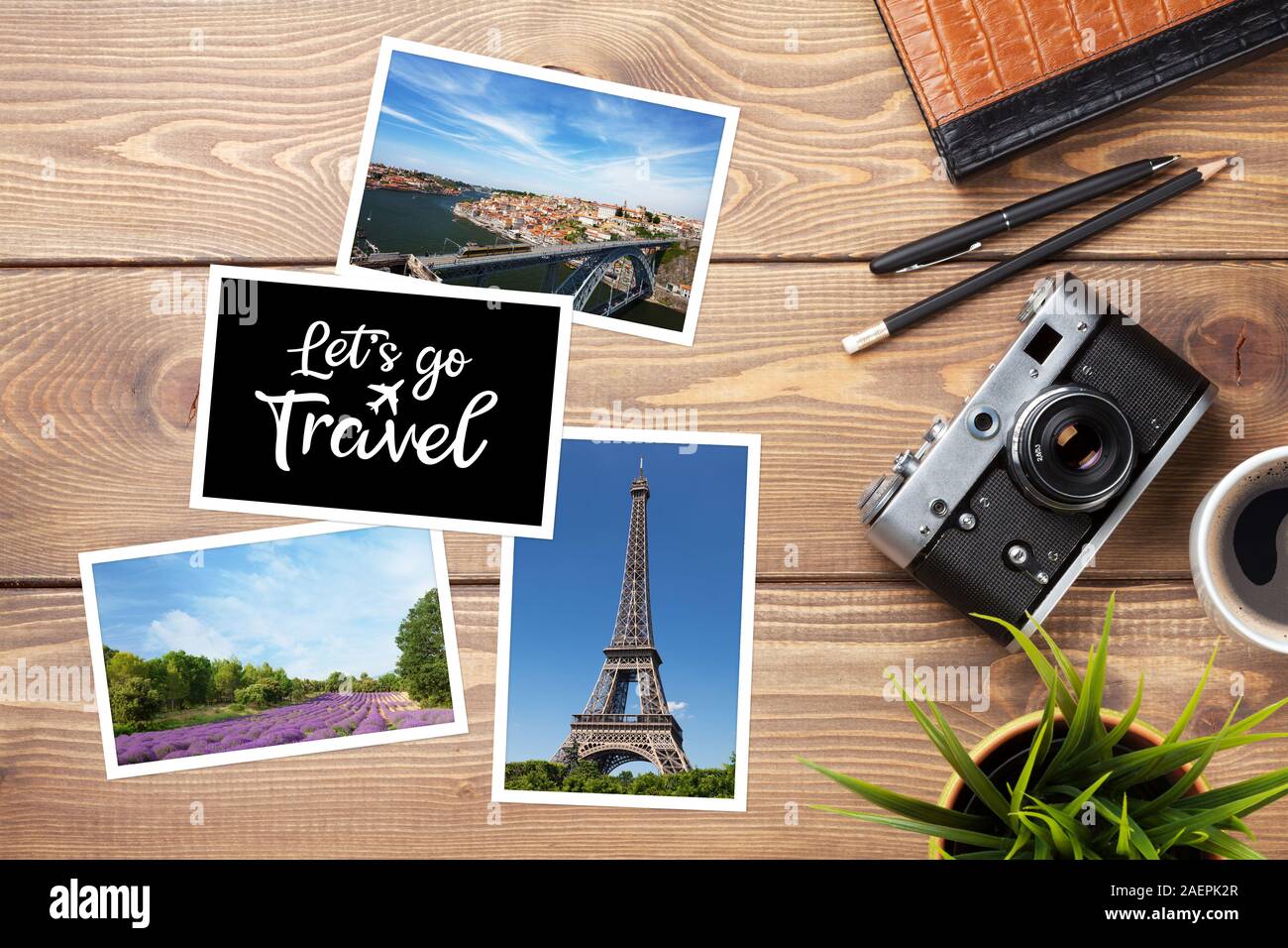 Travel photos, camera and supplies on office wooden desk table. Top view with copy space Stock Photo