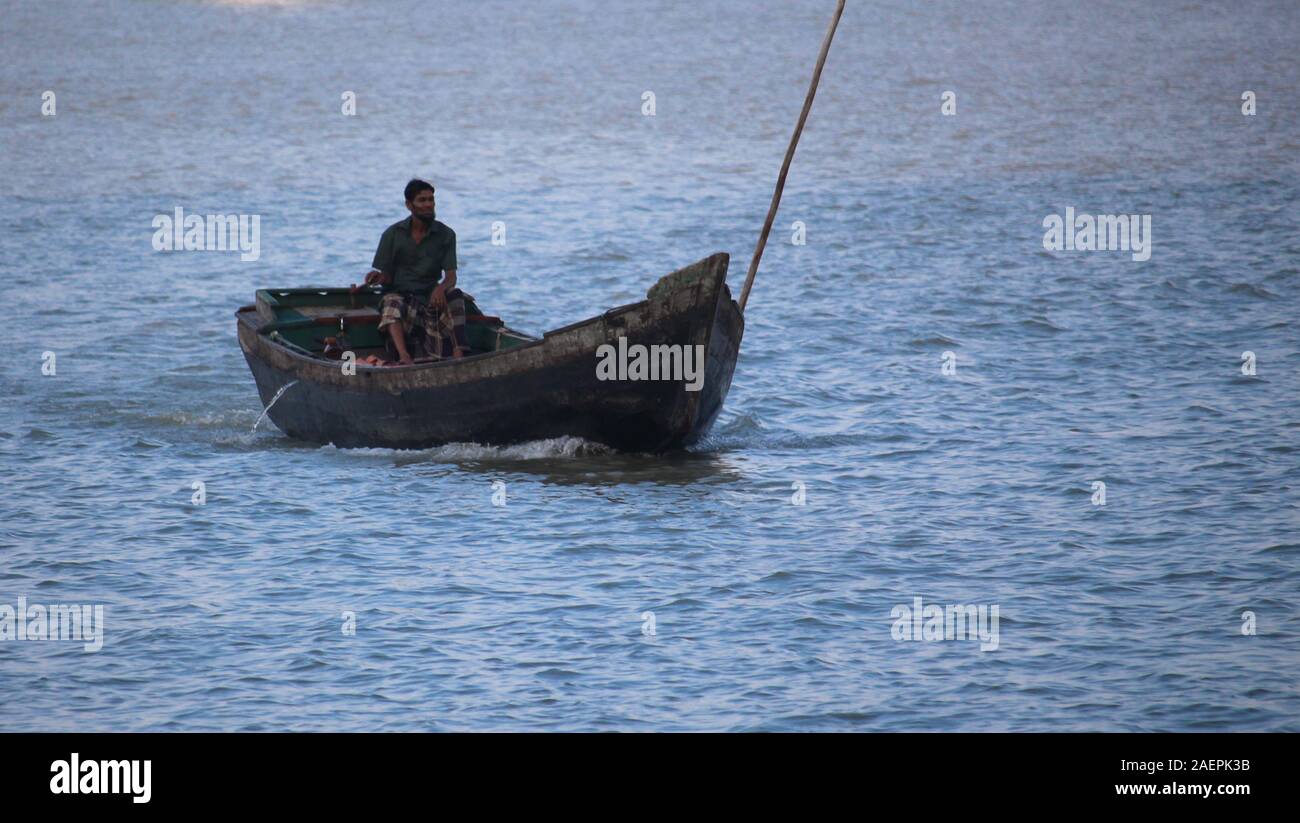 Boats and boatman are located in Barisal district of Bangladesh in the middle of beautiful river Stock Photo