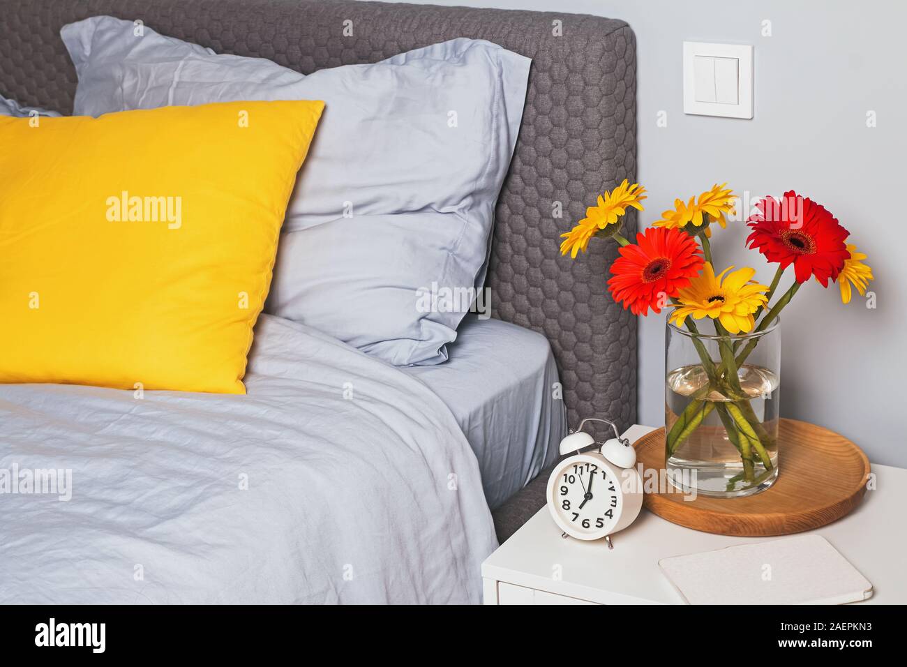 Bedroom Interior With Bright Decorative Pillow On The Bed And