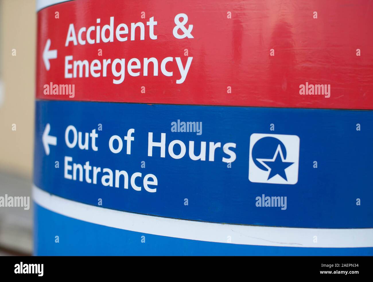 An NHS Hospital sign pointing the way to the Accident and Emergency department and the Out of Hours entrance. Stock Photo