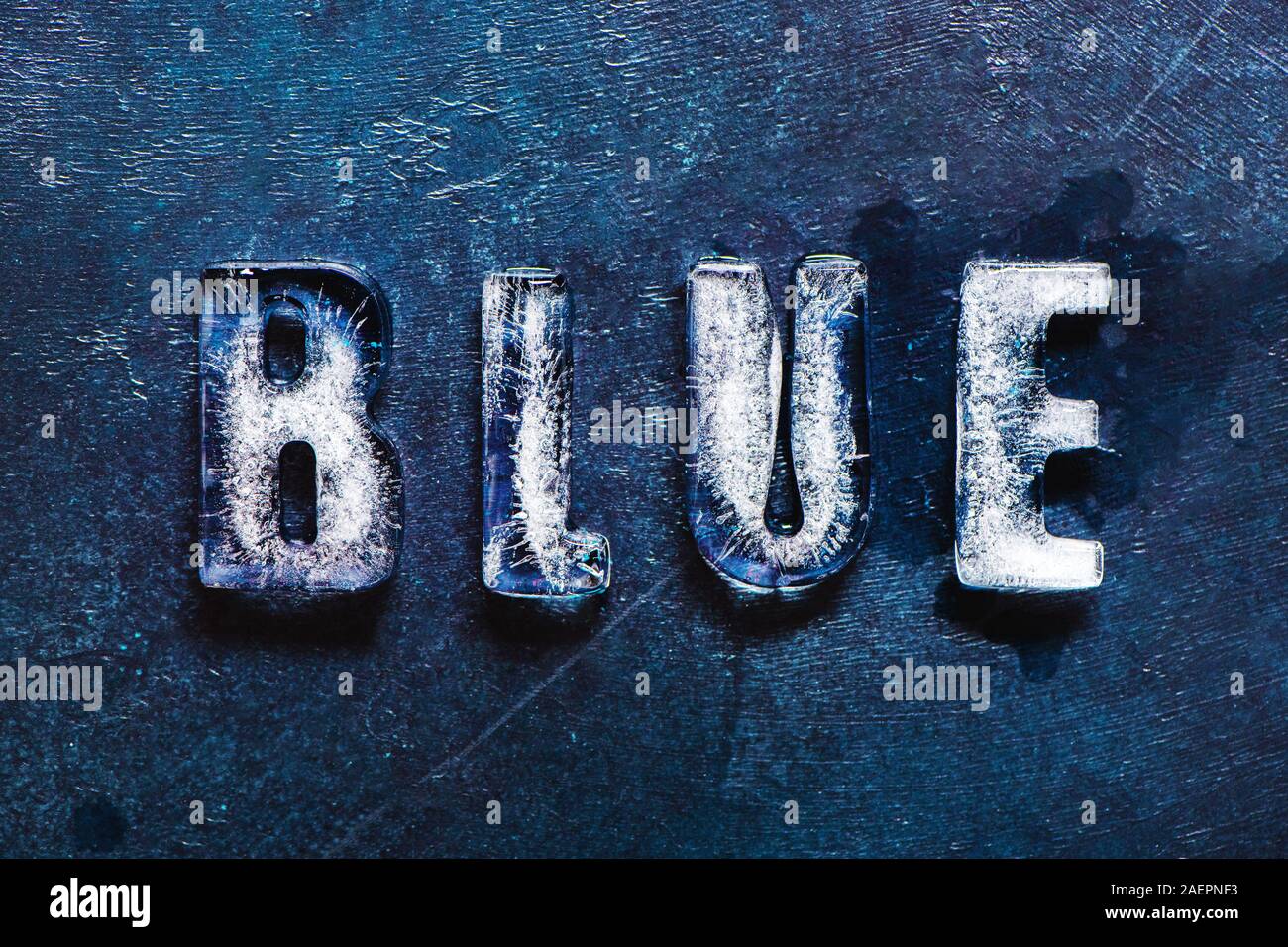 Word Blue made of real ice letters on classic blue background. Stock Photo