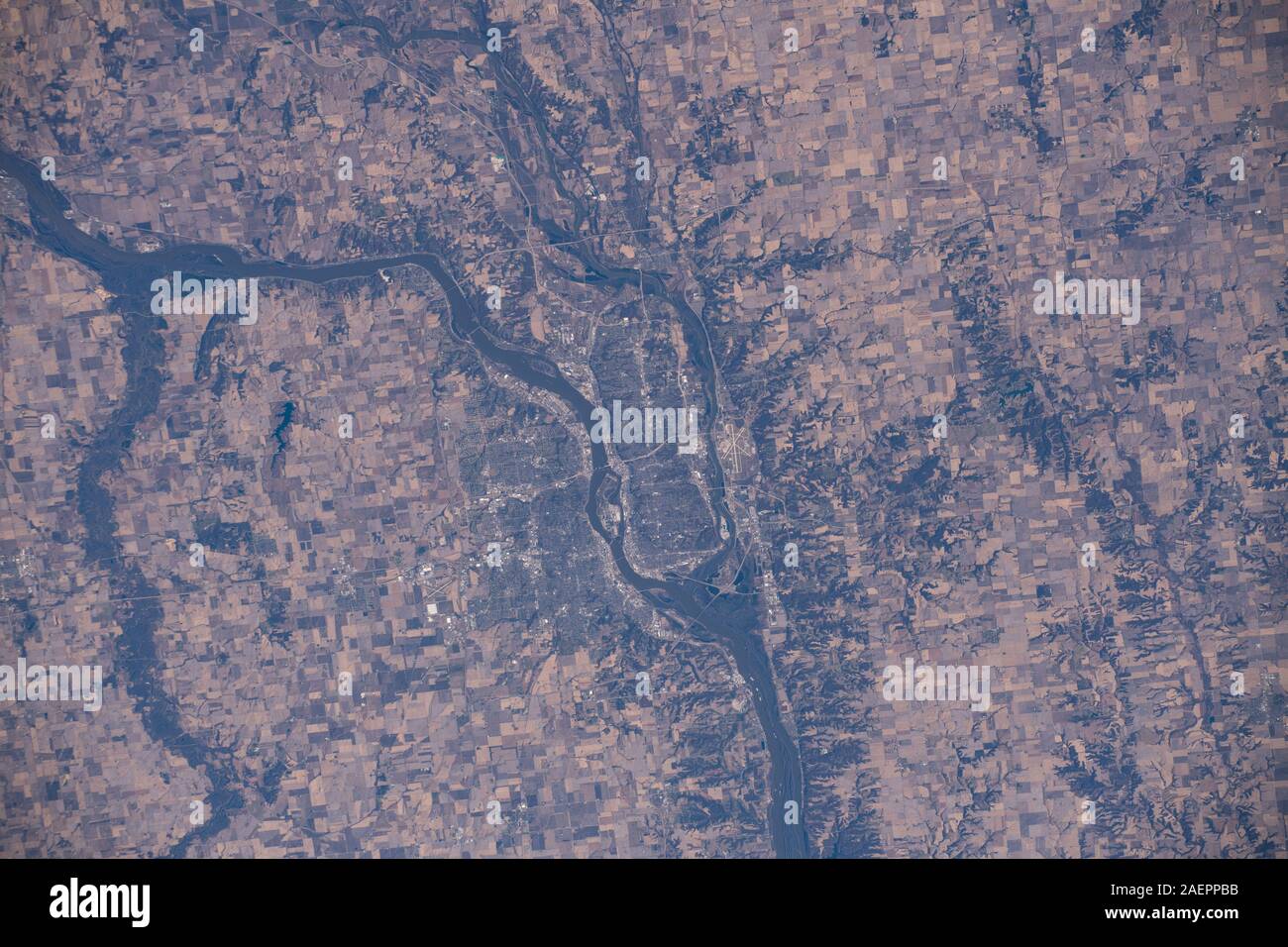 The city of Moline, Illinois surrounded by the Mississippi and Rock Rivers as seem from the International Space Station December 6, 2019 in Earth Orbit. The Mississippi River is the boundary between the states of Illinois and Iowa. Stock Photo