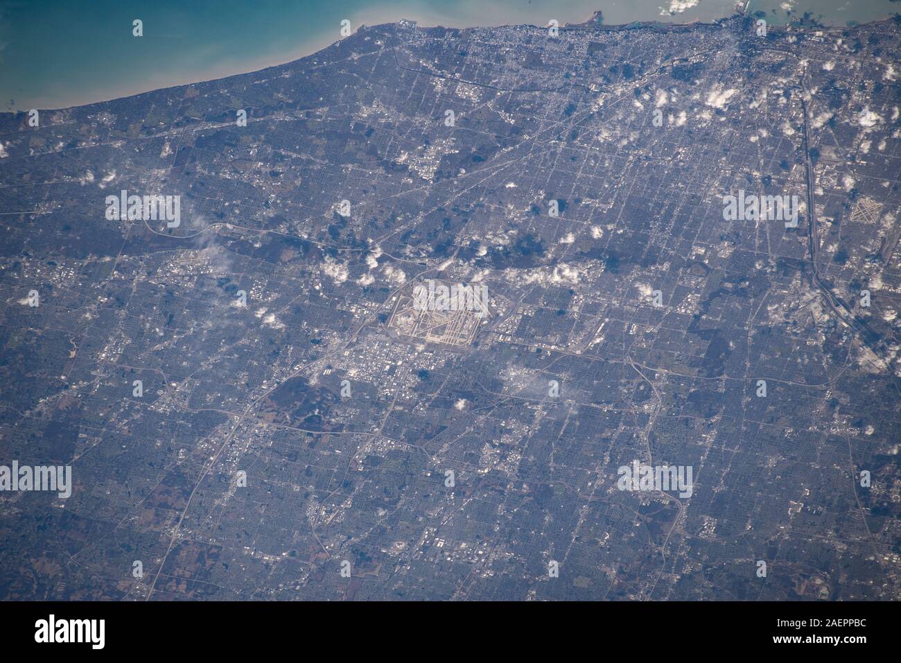 Chicago O'Hare International Airport is centered in this photograph with the Windy City downtown at the top right corner on the coast of Lake Michigan as seem from the International Space Station December 6, 2019 in Earth Orbit. The International Space Station was orbiting 259 miles above the state of Illinois when this picture was taken. Stock Photo