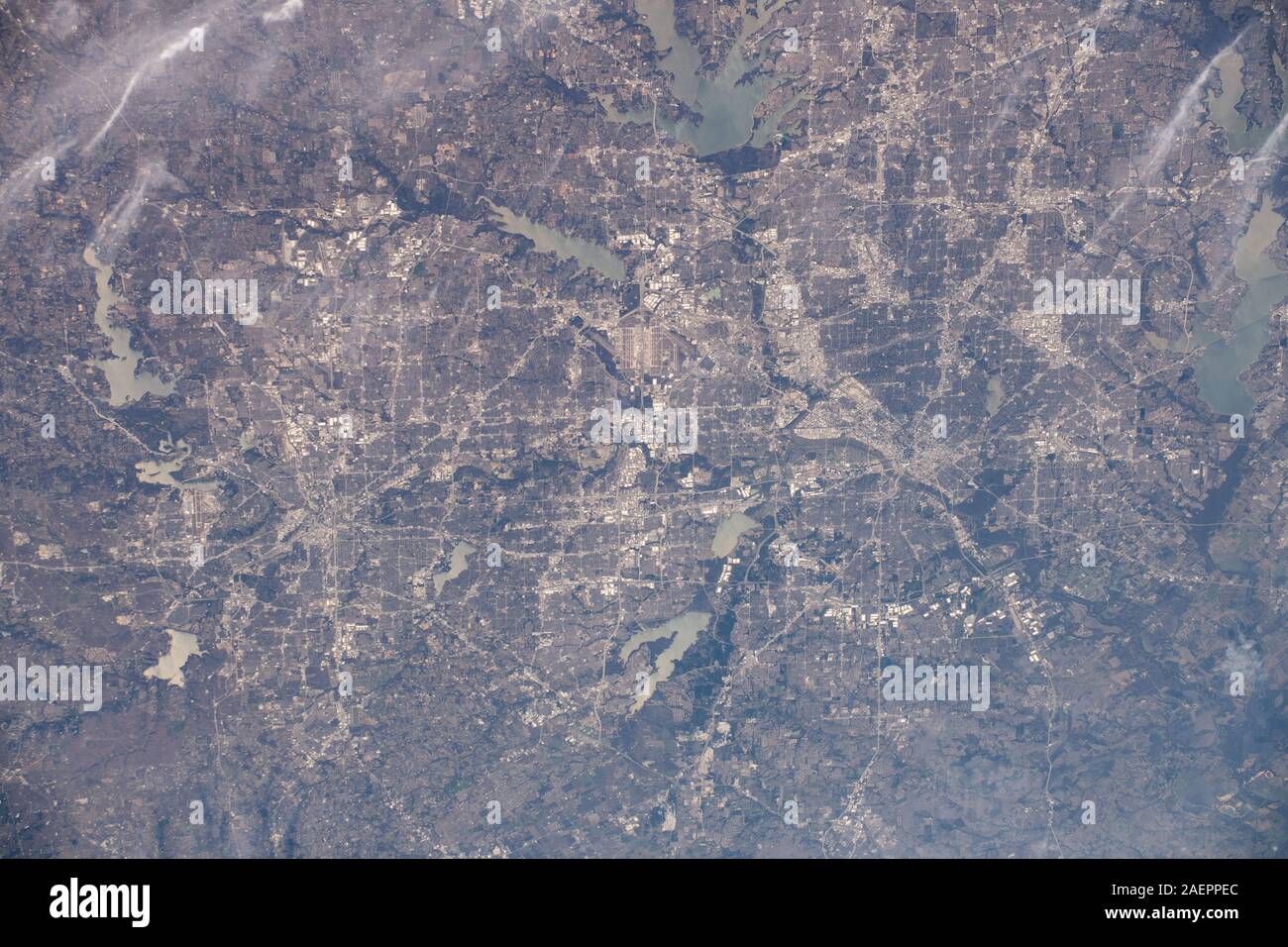 The Dallas-Fort Worth, Texas metropolitan area is pictured along with such landmarks as DFW International Airport and Dallas Love Field Airport as seem from the International Space Station orbiting 258 miles above the state of Texas December 6, 2019 in Earth Orbit. Several bodies of water are pictured including Joe Pool Lake, Mountain Creek Lake, White Rock Lake, Lake Ray Hubbard, Lewisville Lake and Grapevine Lake among others. Stock Photo
