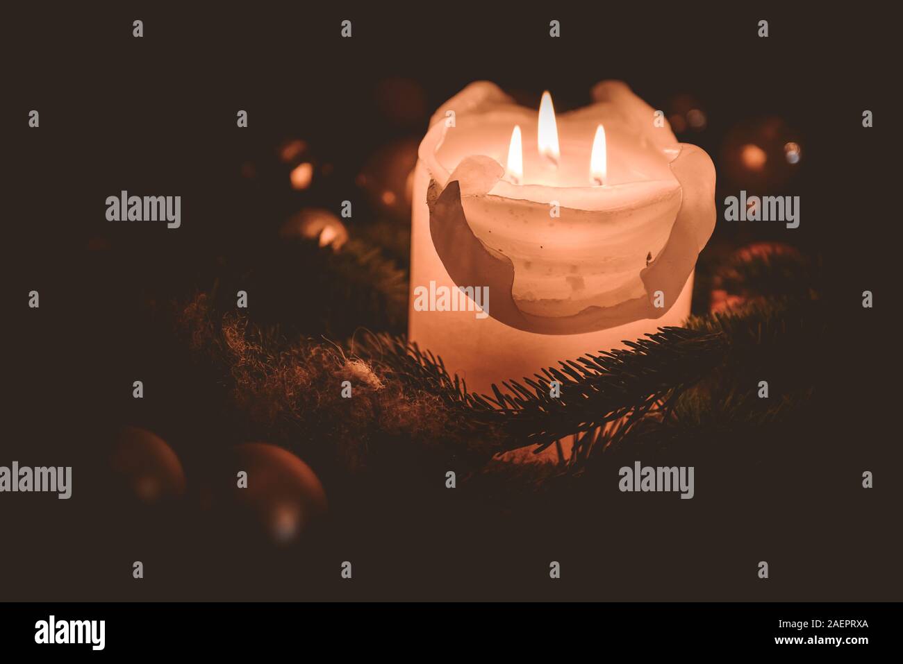 lighting the candle on the Advent wreath during christmas time Stock Photo