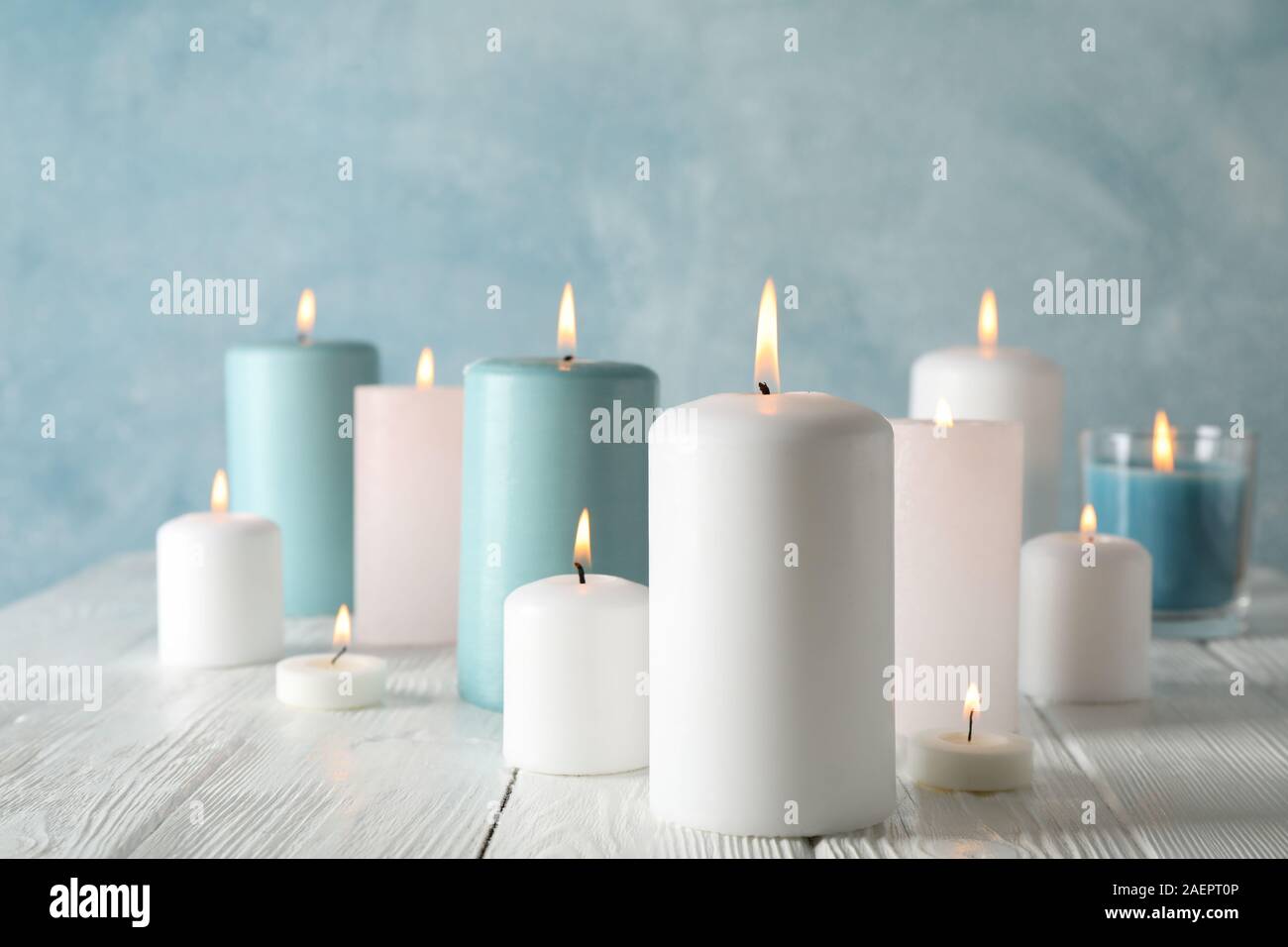 Different burning candles against blue background, space for text Stock ...