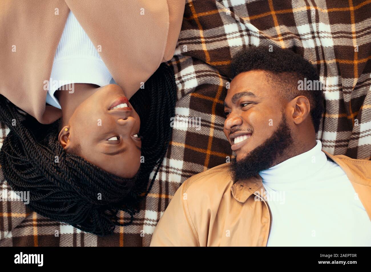 Top view of romantic afro couple lying on picnic plaid outdoors Stock ...