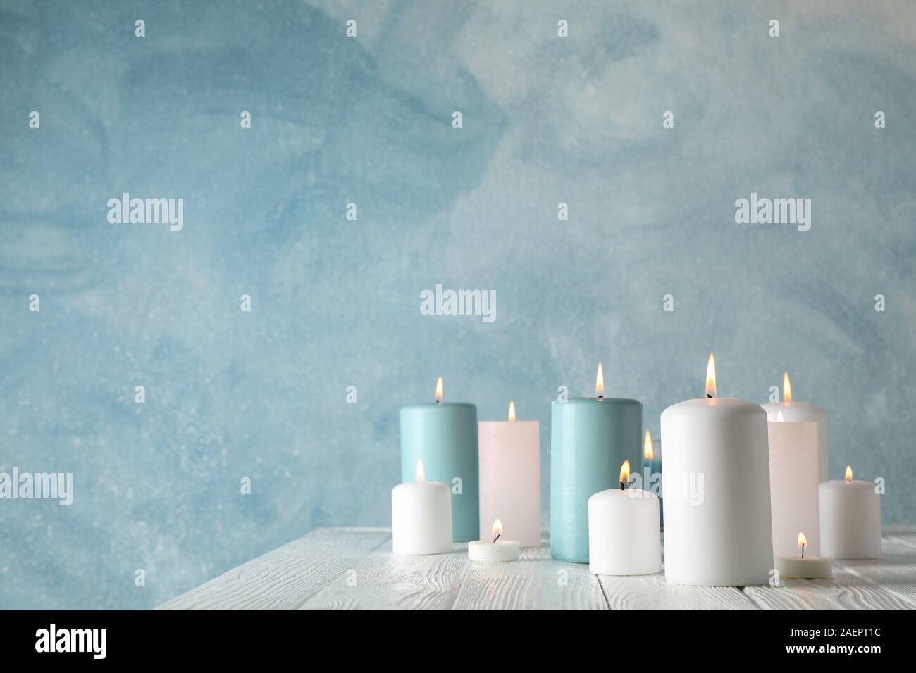 Different burning candles against blue background, space for text Stock ...