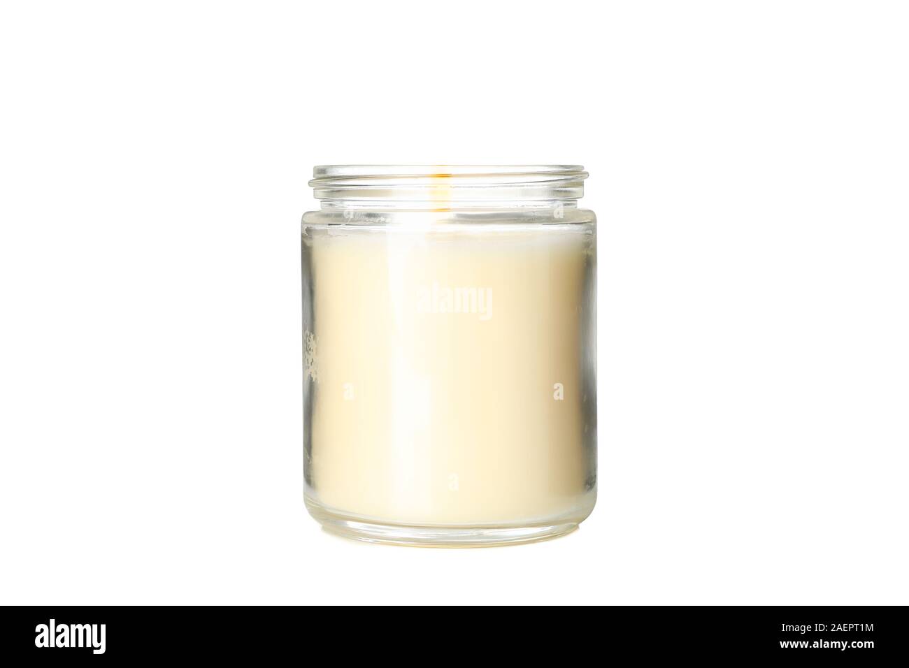 Yellow burning candle in glass jar isolated on white background Stock