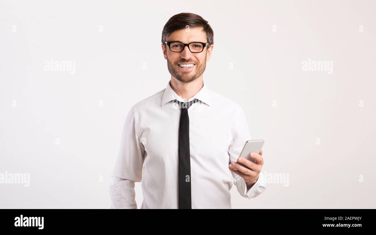 Smiling Man Using Mobile Phone Standing Over White Background, Panorama Stock Photo