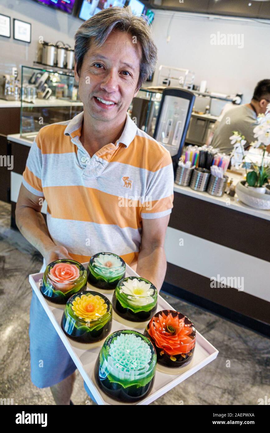 Orlando Florida,East Colonial Drive,Little Vietnam,Asian,Paris Banh Mi Cafe Bakery,artistic desserts,3D gelatin flower cakes,man,holding tray,manager Stock Photo