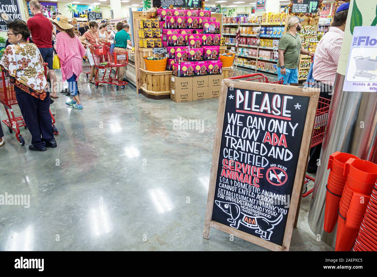 Miami Beach Florida,Trader Joe's,grocery store supermarket food,shopping,interior inside,woman,sign,certified service animals,ADA access,aisles,displa Stock Photo