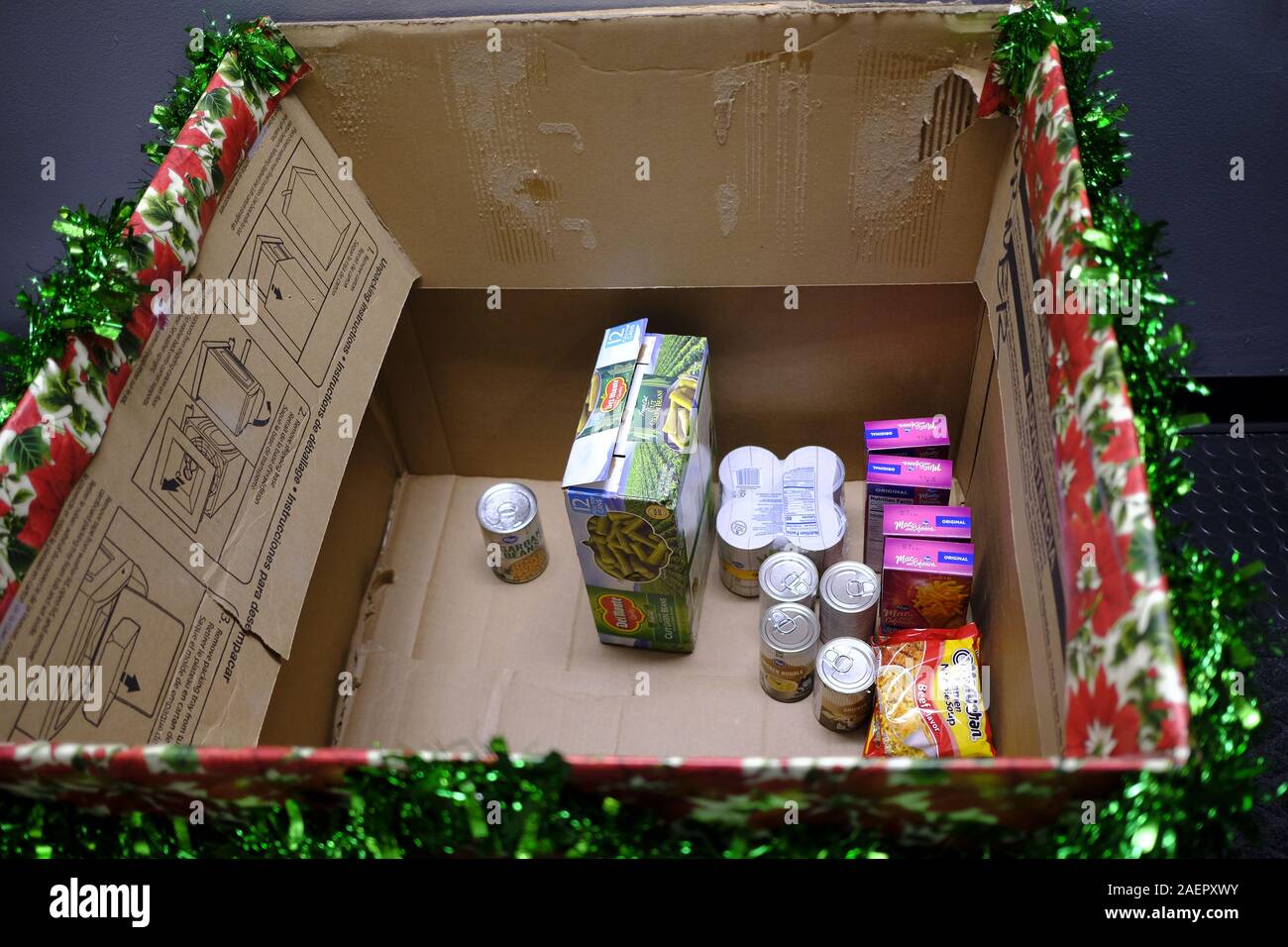 An unfilled box at the Bloomington Fire Department's Station 1 is one of six fire fighters are hoping community members will help fill during a holiday food drive they have organized to fight hunger, Monday, December 9, 2019 in Bloomington, Ind. BFD Capt. Max Litwin, said the boxes are being emptied as they are filled up, so more donations can arrive, but that community members should drop off items by the 15th of December so they can be delivered to those in need on the 16th. (Photo by Jeremy Hogan/The Bloomingtonian) Stock Photo