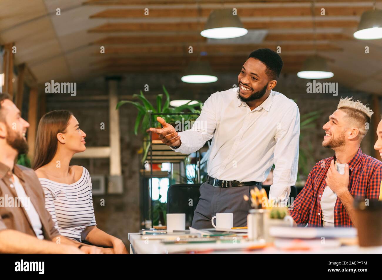 Brainstorming meeting. Chief designer talking with colleagues Stock Photo