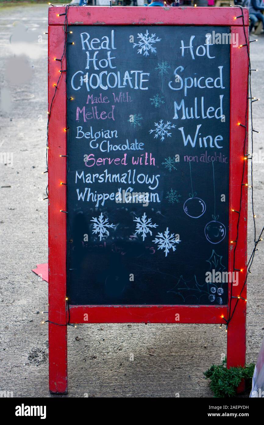 Hot chocolate on a cold December day. A sign advertising hot chocolate and hot mulled wine. Stock Photo