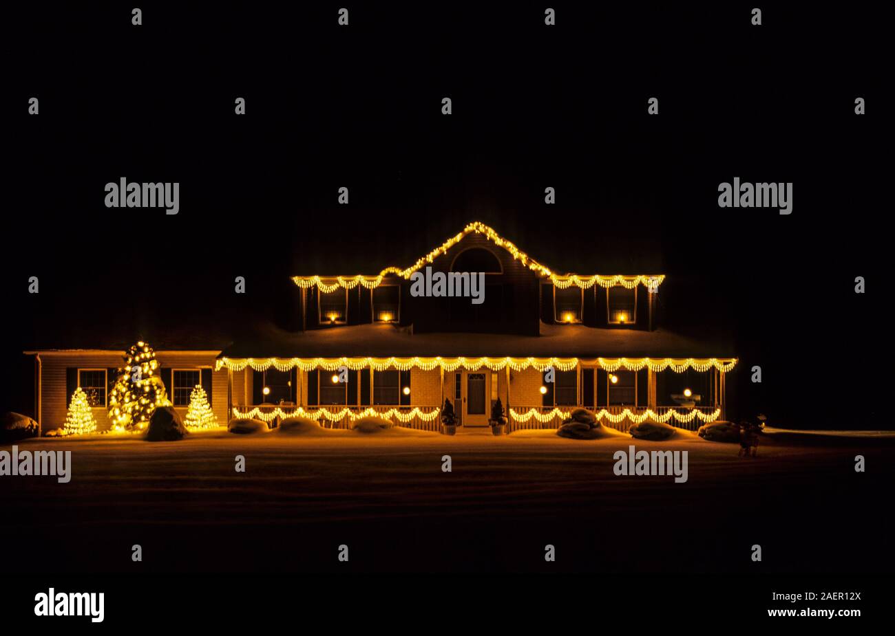 Front of home at night decorated with Christmas lights, New Jersey, USA