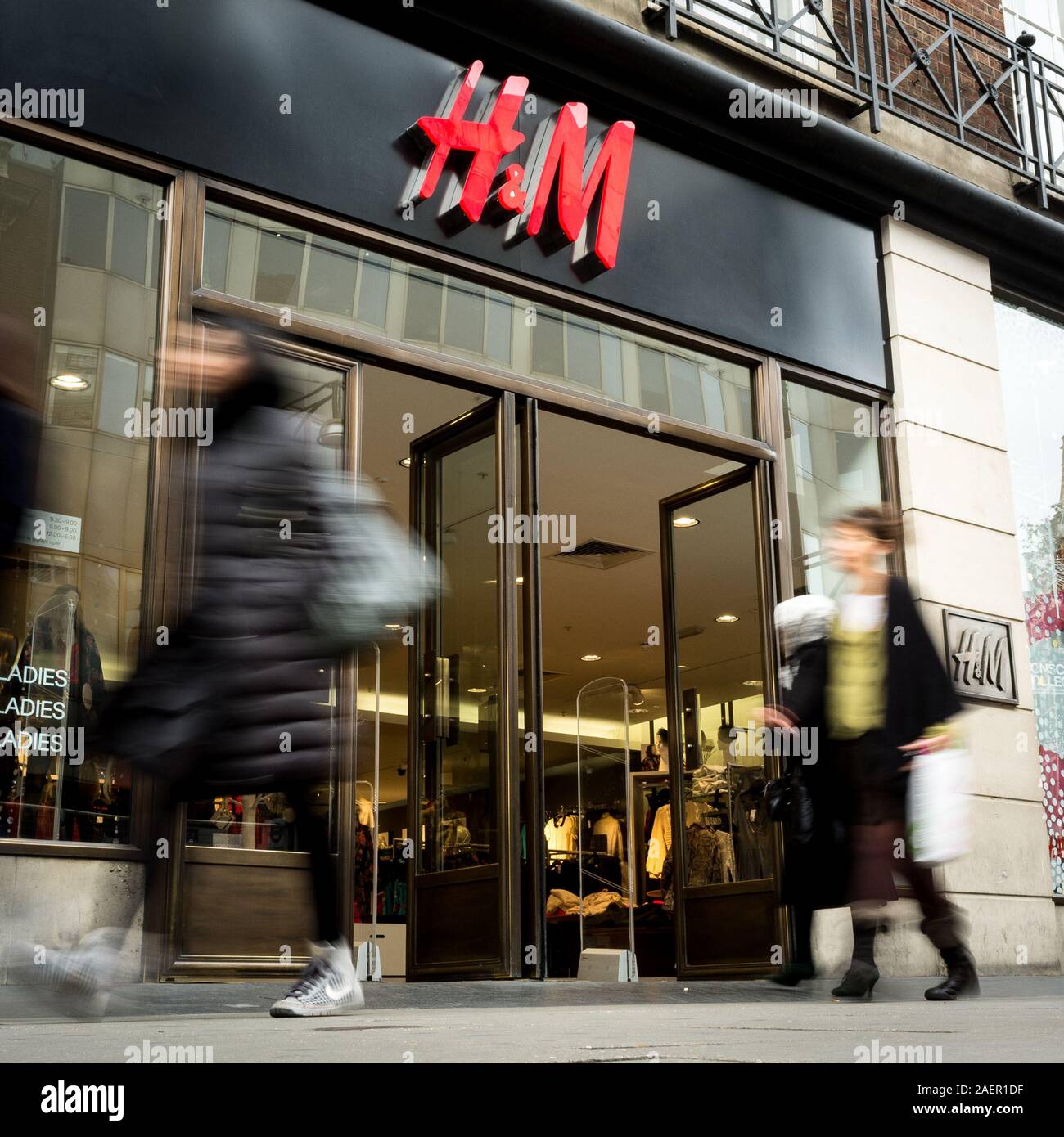 H&M clothes store. Blurred shoppers walking past the shop front to the H&M  shop, a fashion retailer, on London's Oxford Street Stock Photo - Alamy