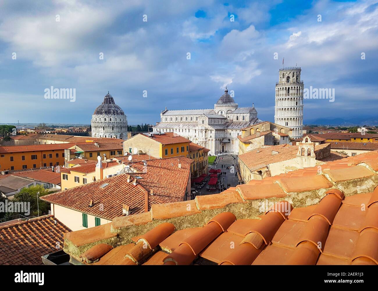 Panoramic view of Pisa, Italy. The leaning Tower, the Cathedral and the Baptistery seen from the roofs of the city center. Stock Photo