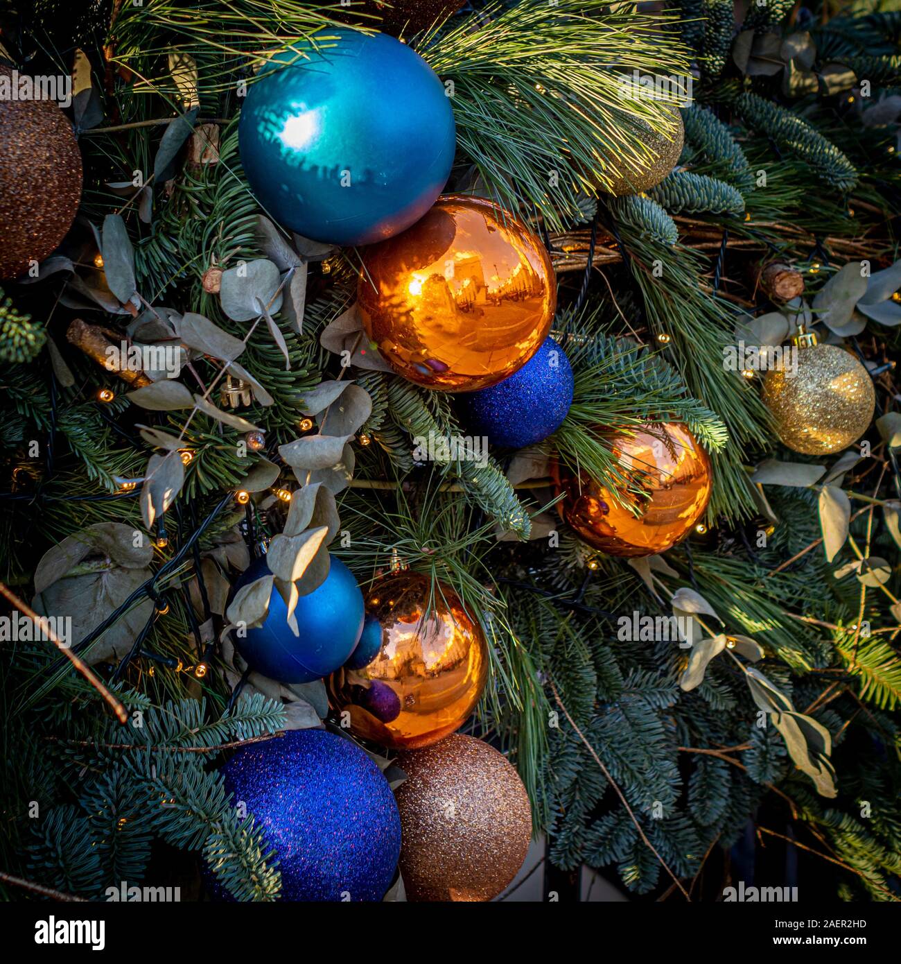 Close up of Christmas garland with Orange and Blue baubles, Belgravia, London, UK. Stock Photo