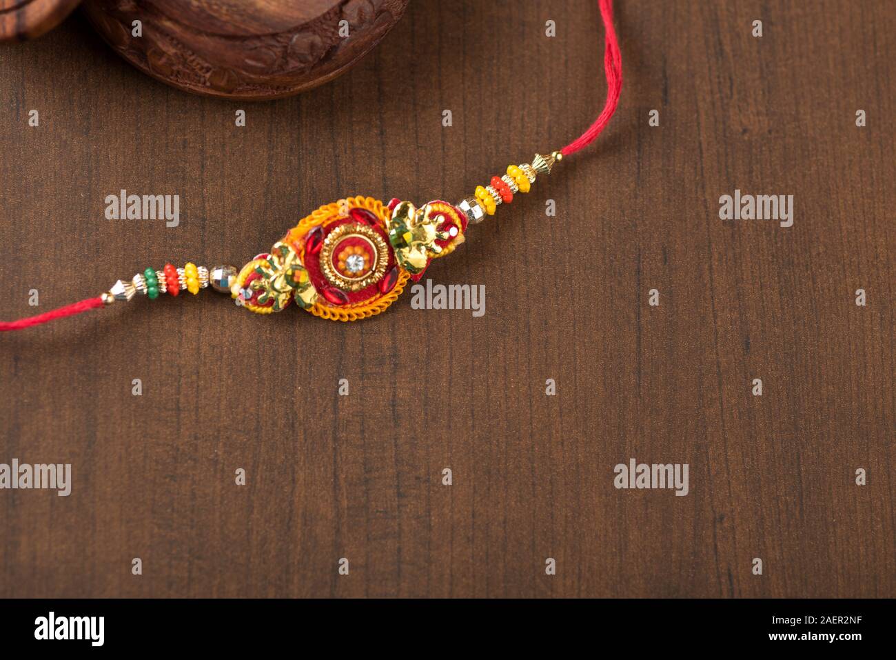 Indian festival: Raksha Bandhan background with an elegant Rakhi, Rice ...