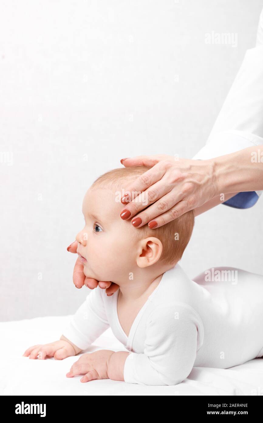 Six month baby girl receiving osteopathic or chiropractic treatment in