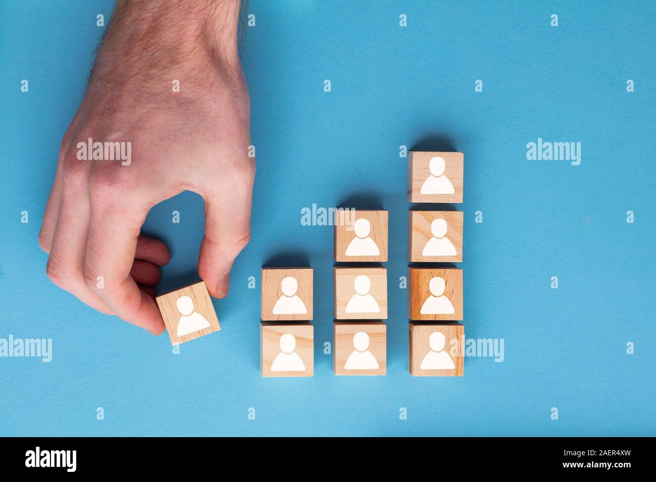 Hand adding a new team member to a group. Business management concept Stock Photo