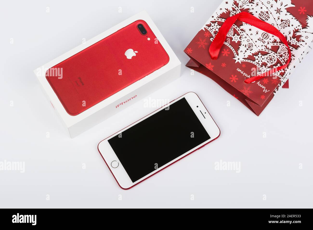 BURGAS, BULGARIA - DECEMBER 10, 2019: Apple iPhone 7 Plus Red Special Edition on white background, front side. Christmas gift. Stock Photo