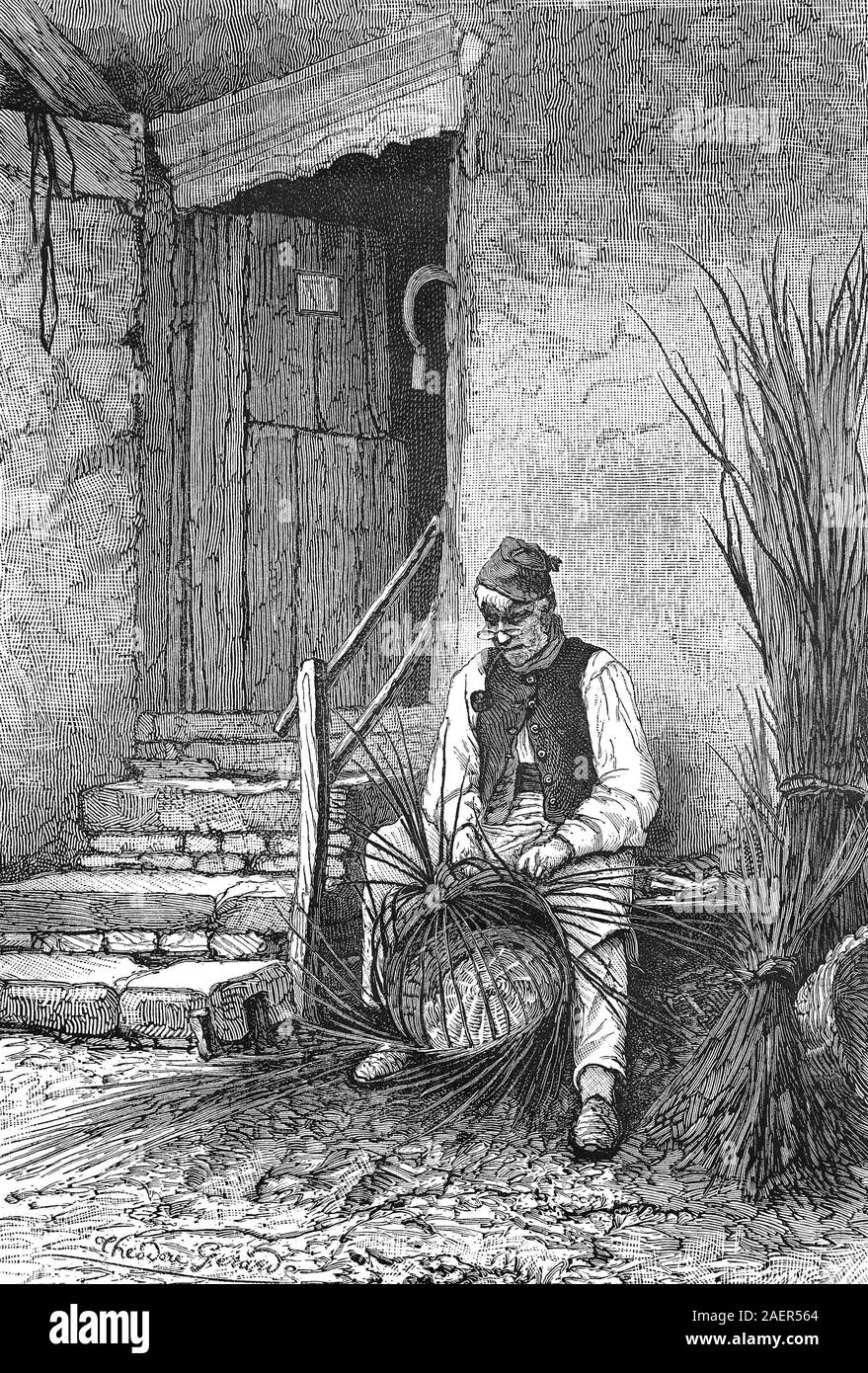 Wicker sits in front of his house and wilts a wicker basket  /  Korbflechter sitzt vor seinem Haus und flechtet einen Weidenkorb, Reproduction of an original 19th century print / Reproduktion von einem Originaldruck aus dem 19. Jahrhundert Stock Photo