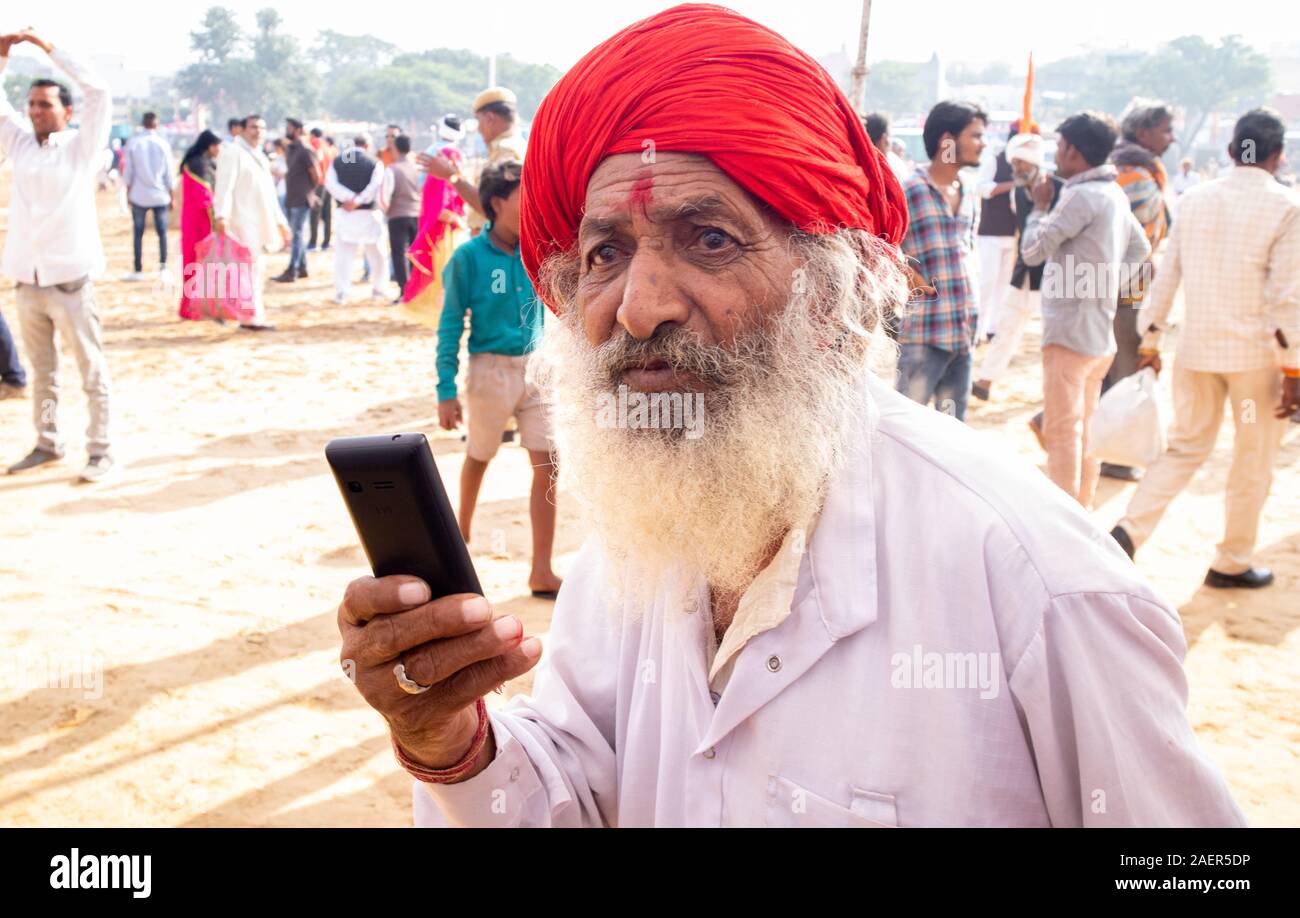Old man using mobile. Digitization of India in Villages . Indian telecommunication in villages. Stock Photo