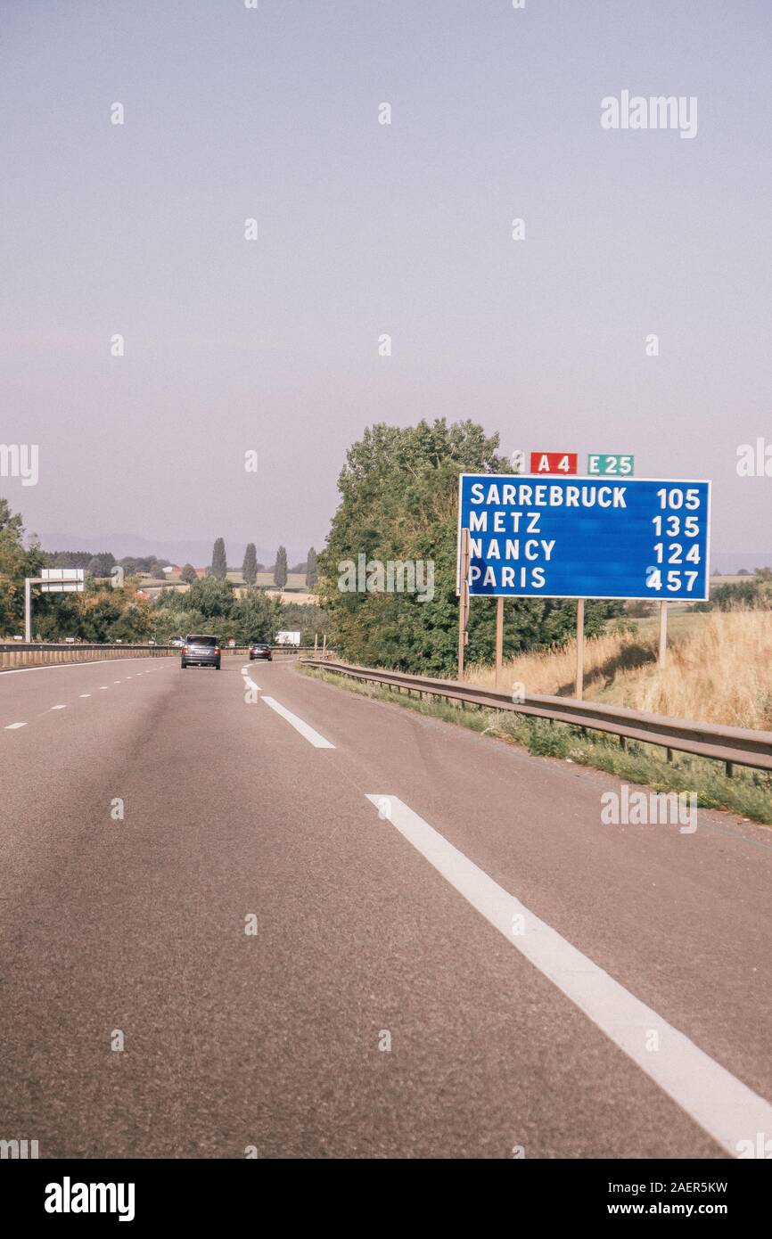 Street Sign indicating distance to Paris, France Stock Photo