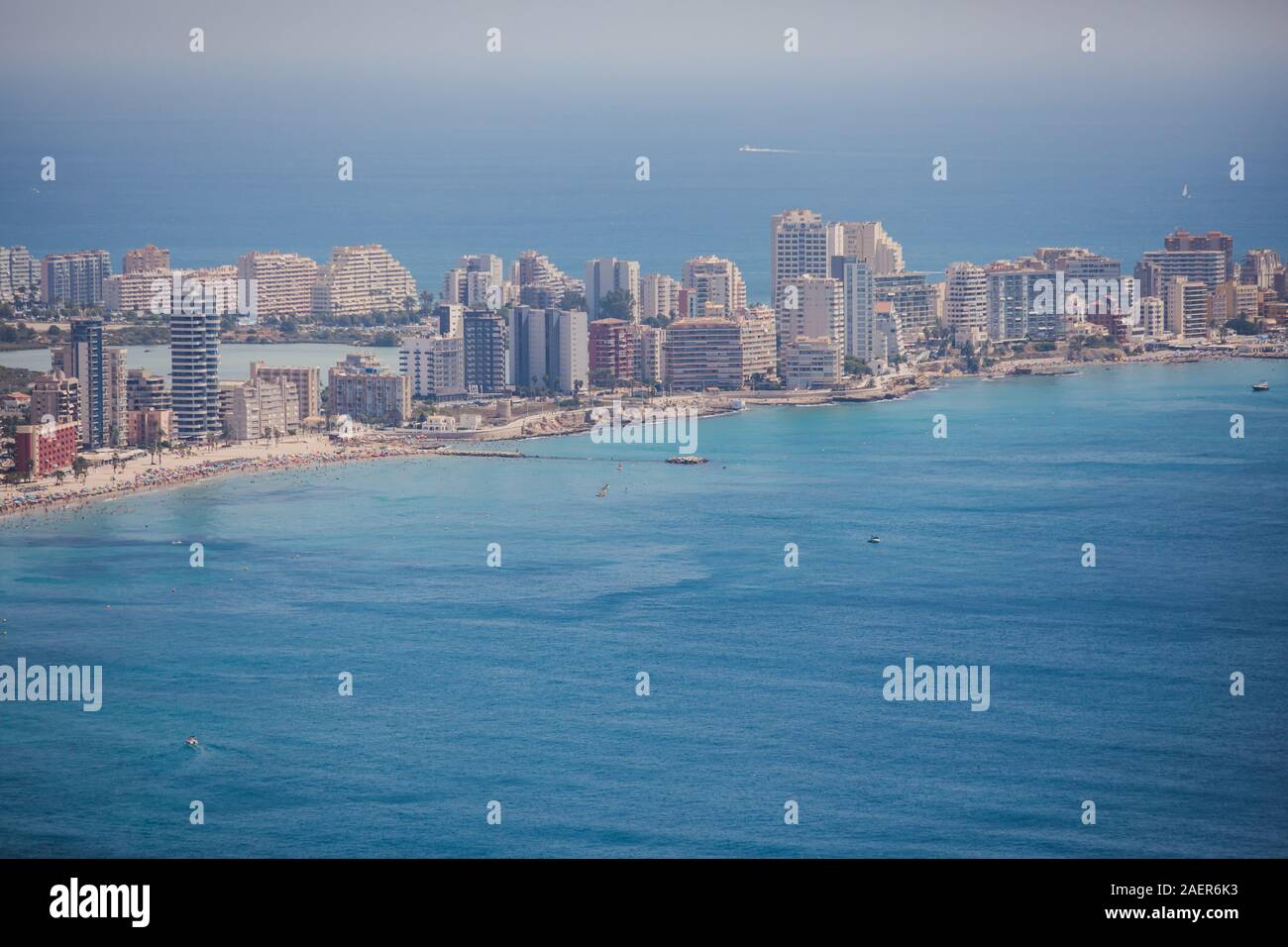 Beautiful super wide-angle aerial view of Calpe, Calp, Spain with harbor and skyline, Penon de Ifach mountain, beach and scenery beyond the city, seen Stock Photo