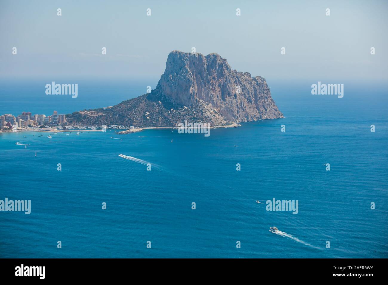 Beautiful super wide-angle aerial view of Calpe, Calp, Spain with harbor and skyline, Penon de Ifach mountain, beach and scenery beyond the city, seen Stock Photo