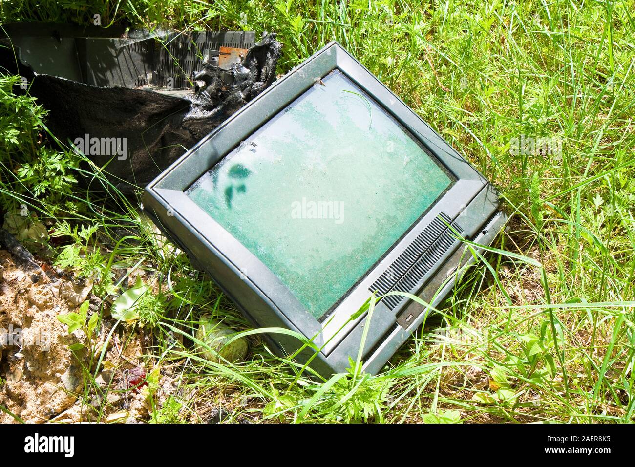 Old television CRT abandoned in a illegal dump - toned image Stock Photo