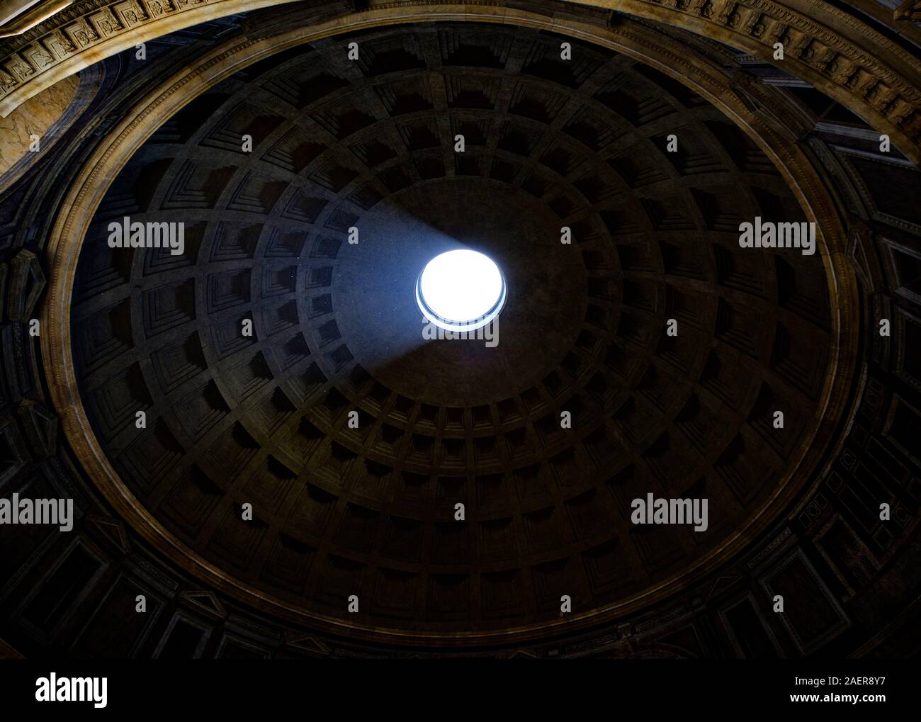 A shaft of sunlight illuminates the vaulted interior of the Pantheon dome. Rome, Italy. Stock Photo