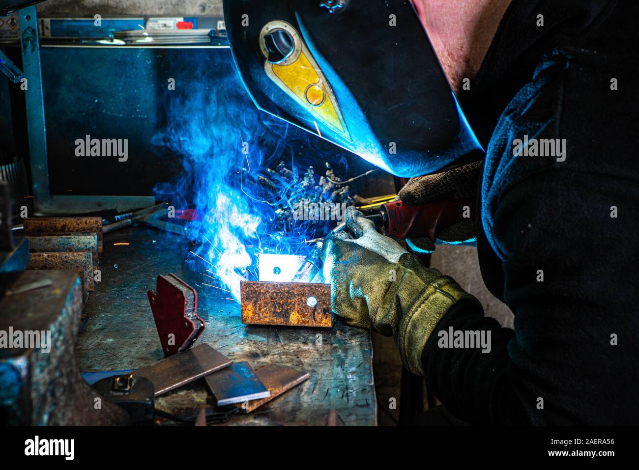 Electric welding process. Worker in welding mask. Bright white and blue Stock Photo Alamy