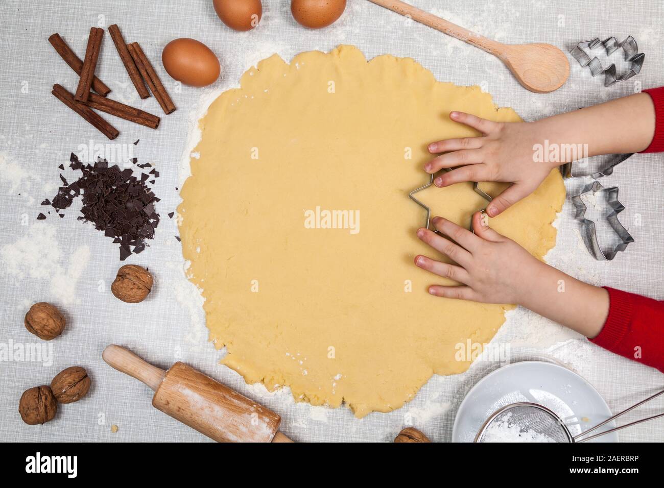 Child cuts out cookies from dough Stock Photo