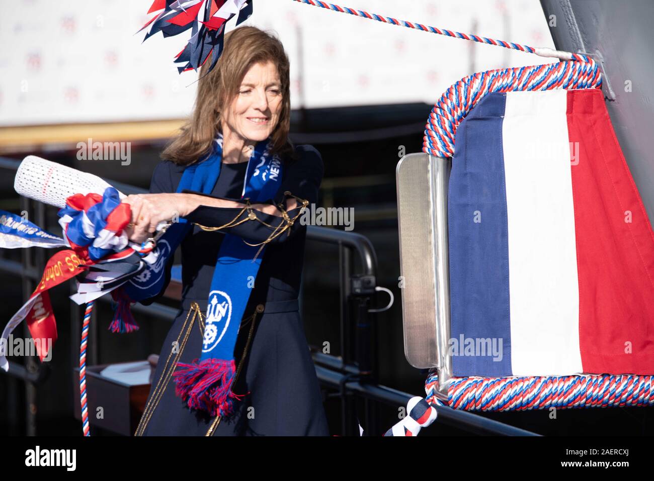 Amb. Caroline Kennedy, daughter of the late President John F. Kennedy swings a bottle of champagne to christen the new Ford-class aircraft carrier USS John F. Kennedy at Huntington Ingalls Industries December 7, 2019 in Newport News, Virginia. Kennedy is the second ship in the next-generation Ford-class of nuclear-powered aircraft carriers and the second U.S. aircraft carrier named for President Kennedy, with the former retired from service in 2007. Stock Photo