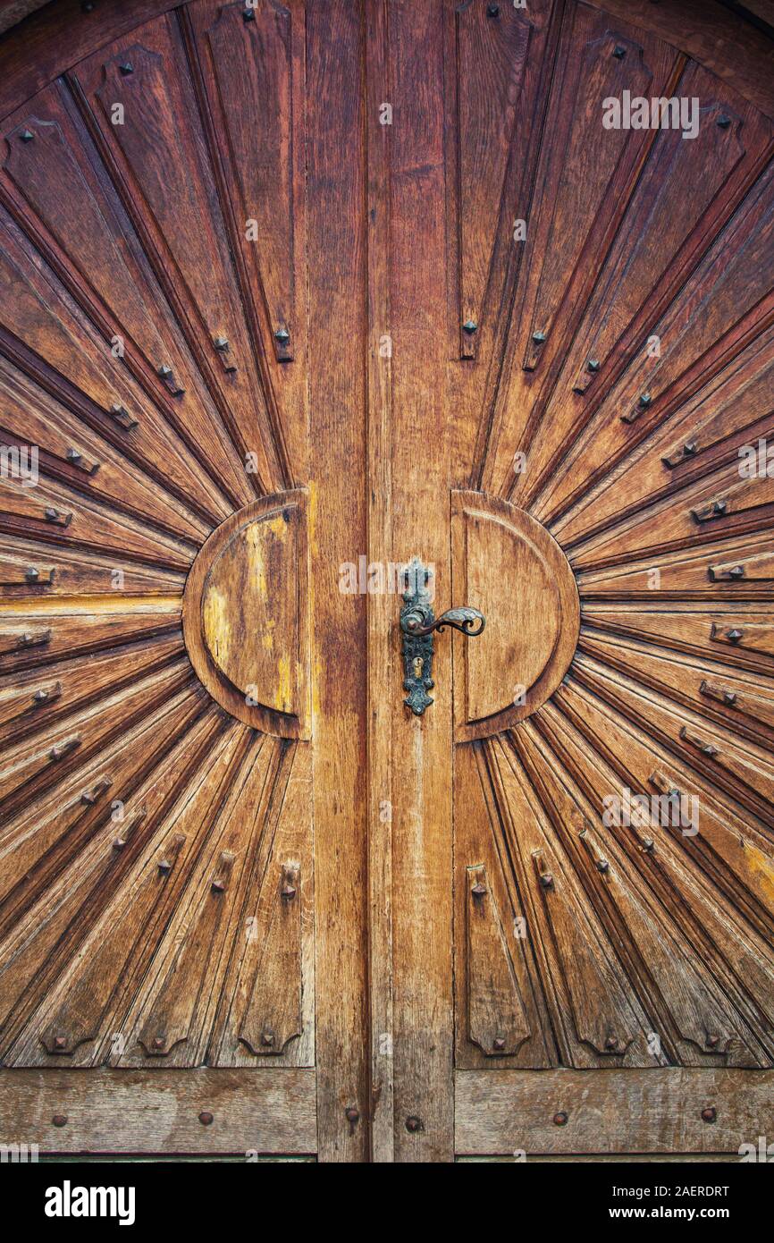 Old wooden door background showcase traditional antique ornaments. Beautiful wood carving doorway entrance. Stock Photo