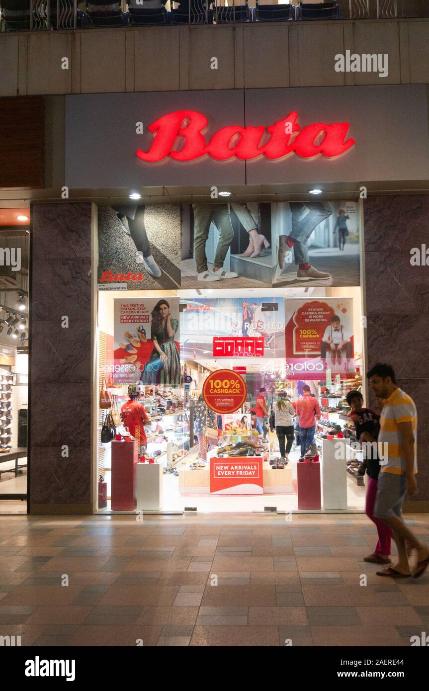 Shop exterior of a bata store in a busy shopping mall at night Stock Photo