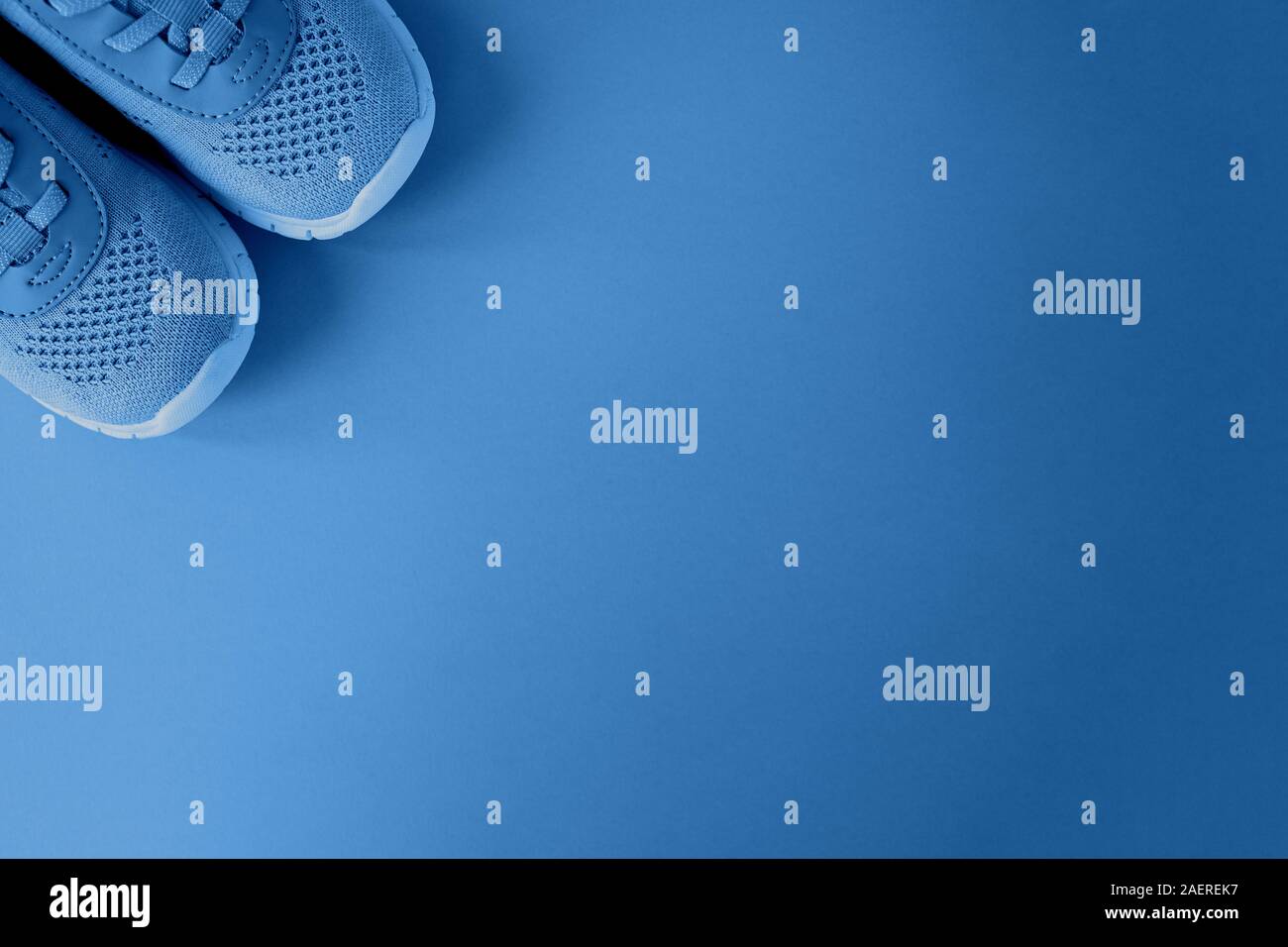 Sport, healthy lifestyle, color of the year 2020 concept. New sneakers on background in trendy color Classic Blue. Copy space. For fitness blog, socia Stock Photo