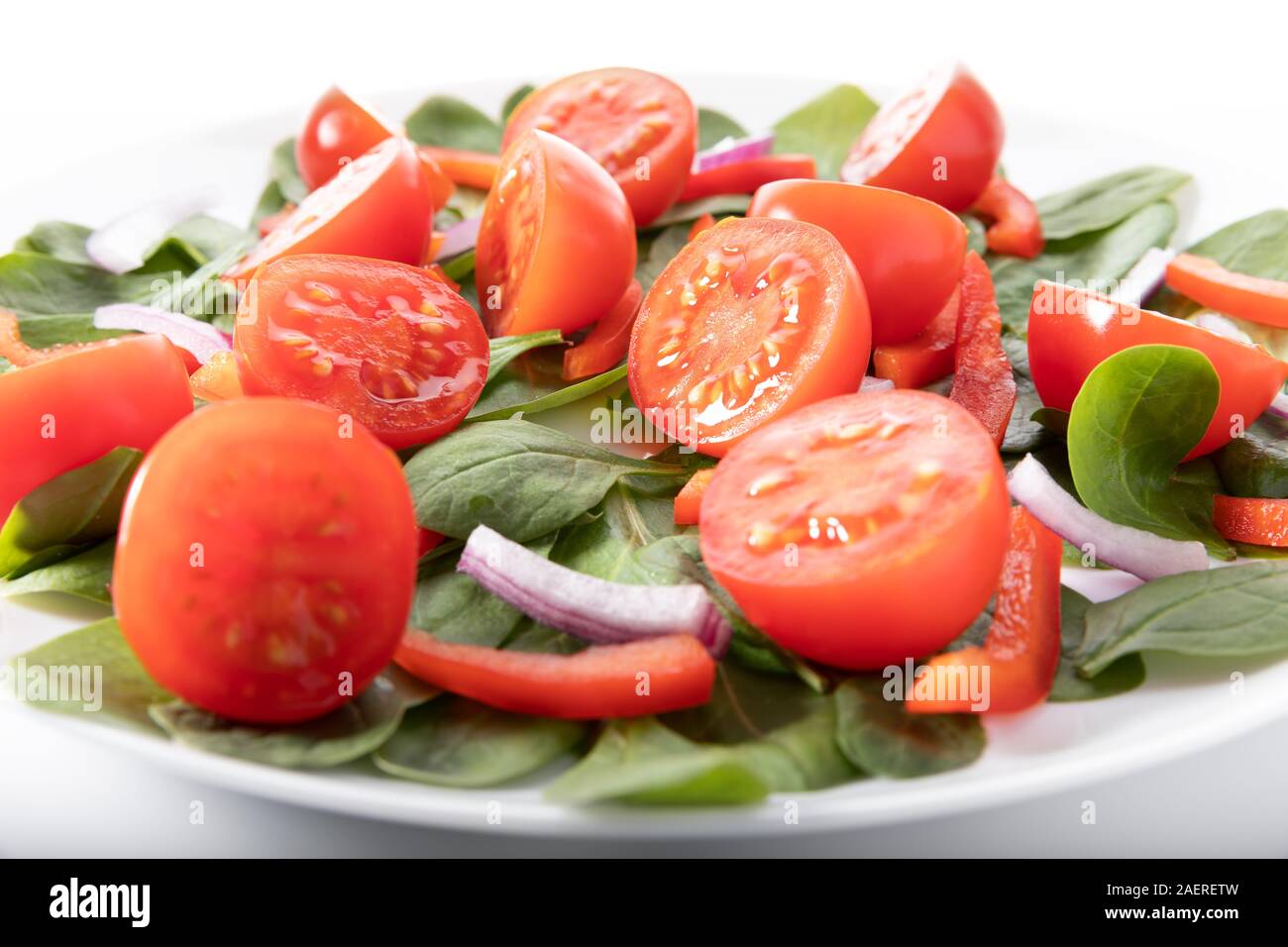 Fresh salad with tomatoes, isolated on white background Stock Photo