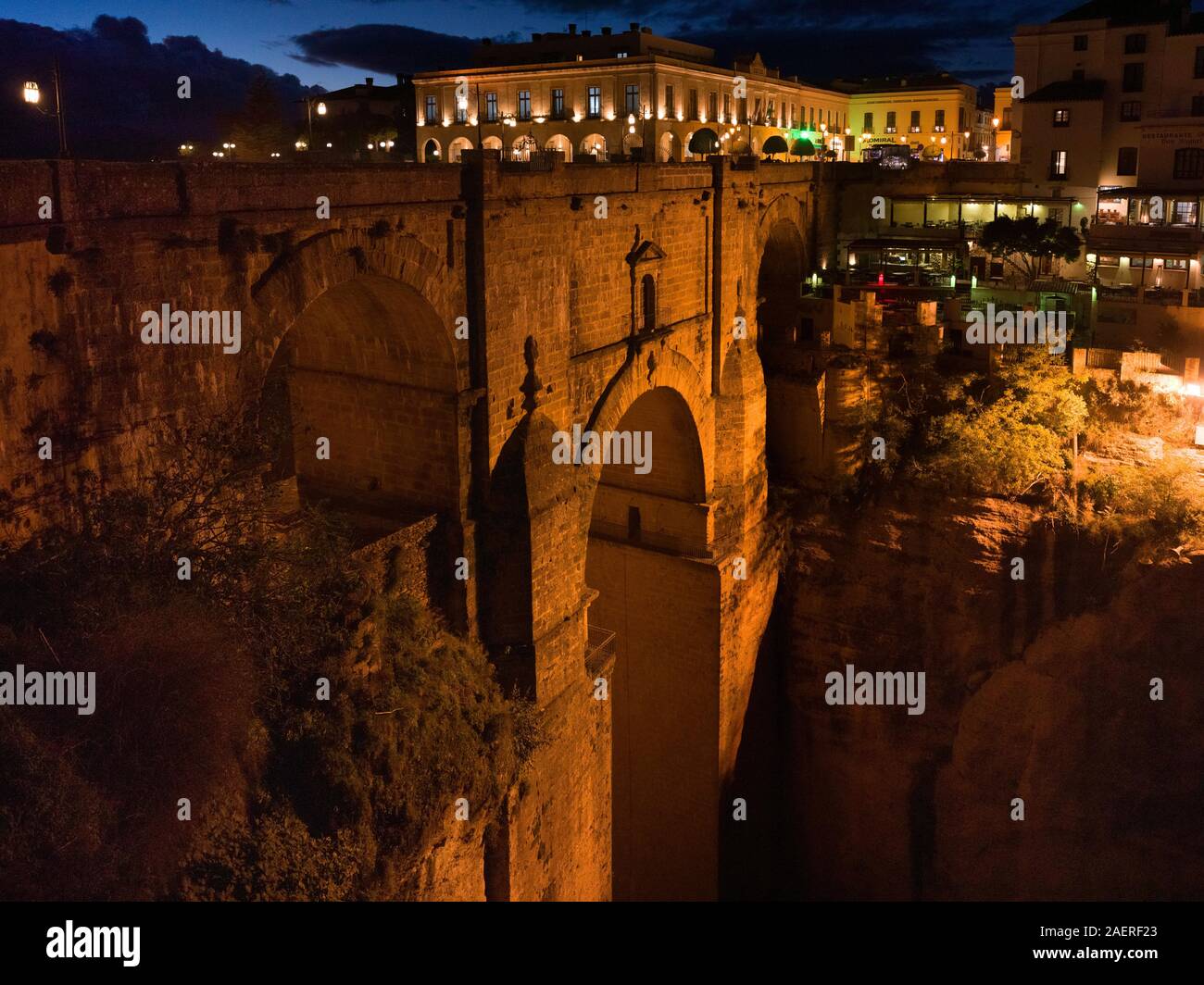 Illuminated city on top of Puente Nuevo Bridge, Ronda, Malaga Province, Spain Stock Photo