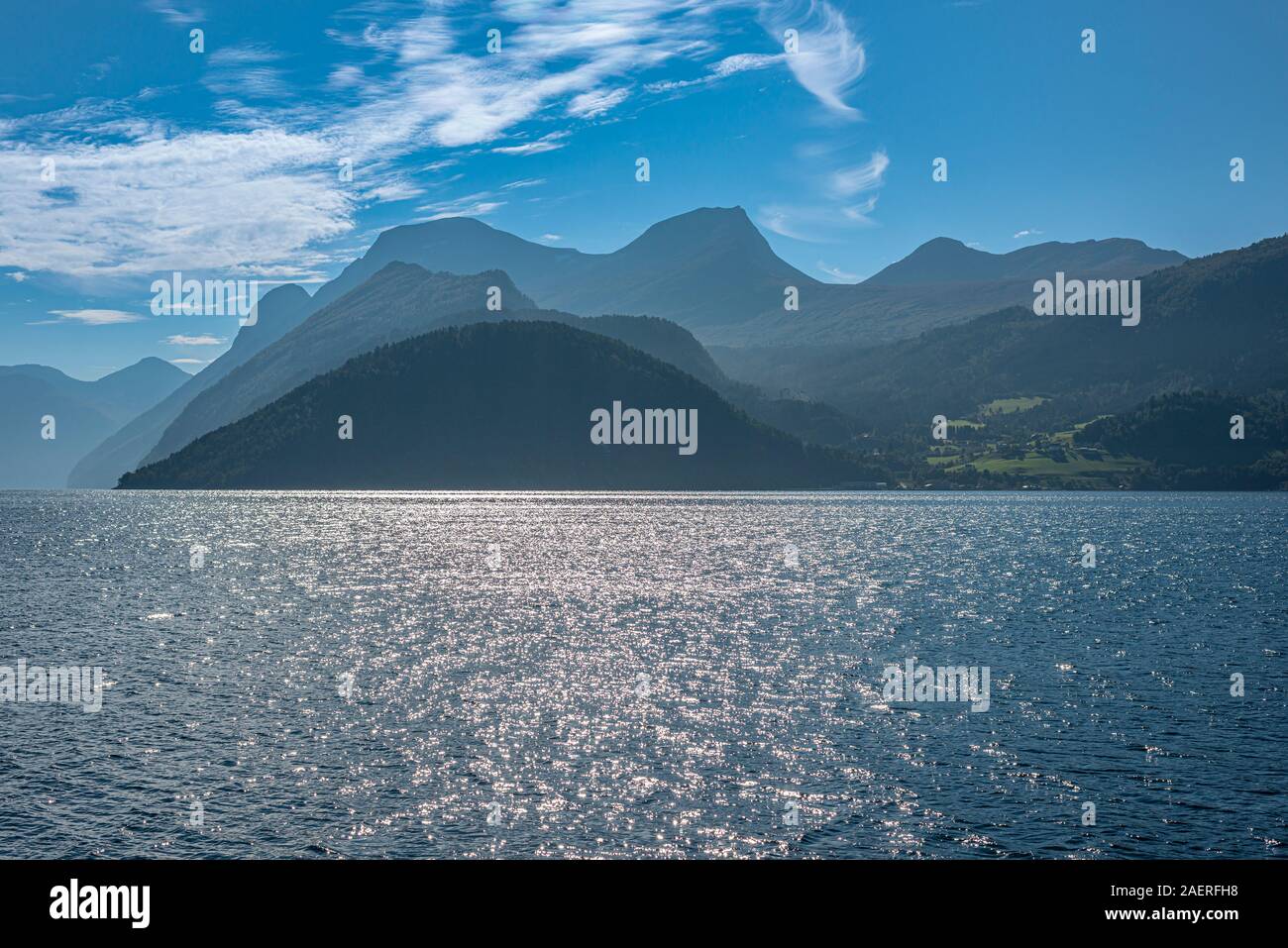 Norddalsfjord, view from the Linge ferry terminal to the south, backlit mountain ranges, near Eidsdal, More og Romsdal, Norway Stock Photo
