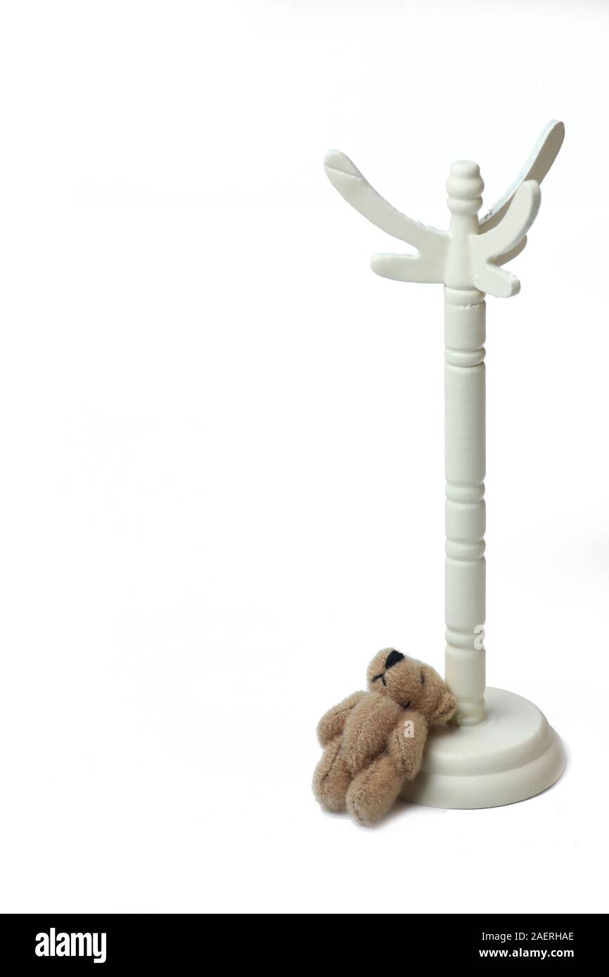 white coat rack and teddy bear isolated on white background. Image ...
