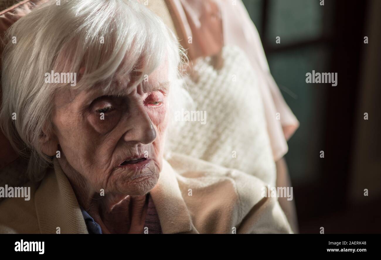 The ninety year old lady is covered in an insulating blanket to try and stay warm and is unable to leave her house unaided as she is registered blind. Stock Photo